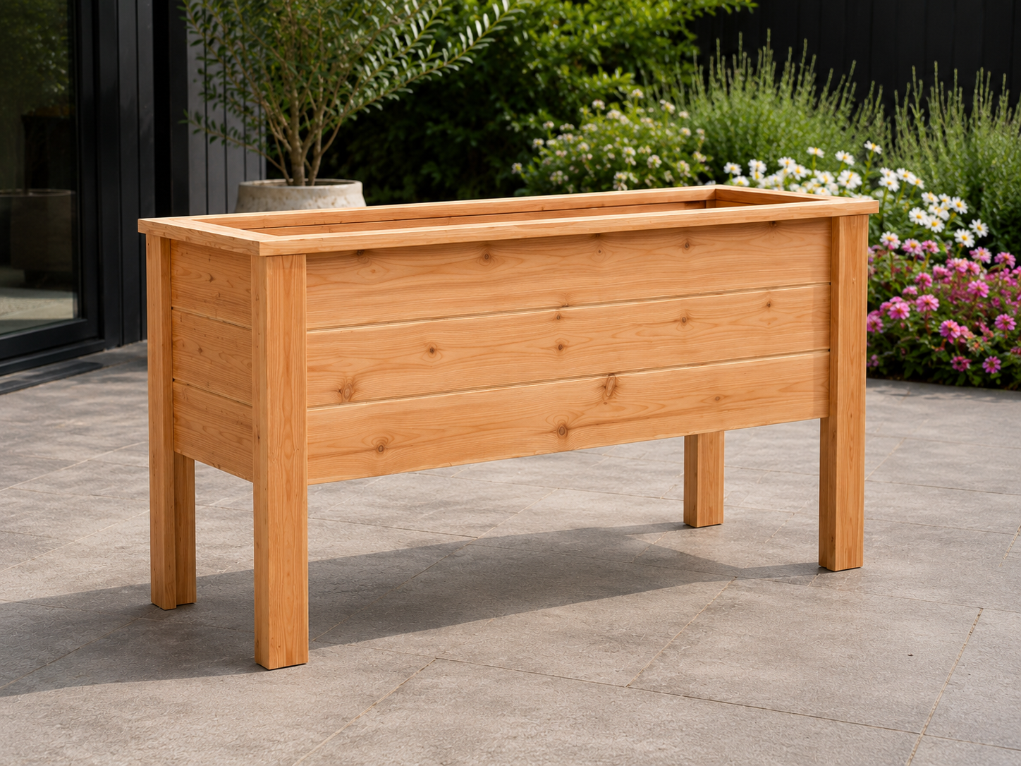 Waist-height raised cedar garden planter growing vegetables