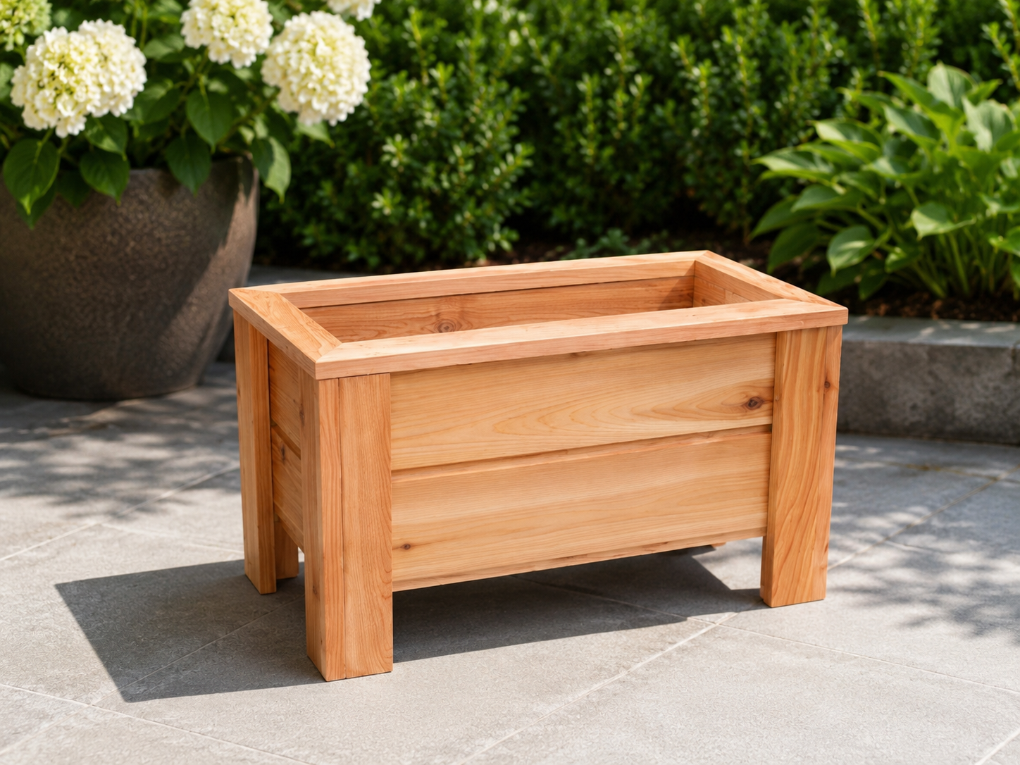 Classic cedar patio planter with leafy plants on a small wooden deck