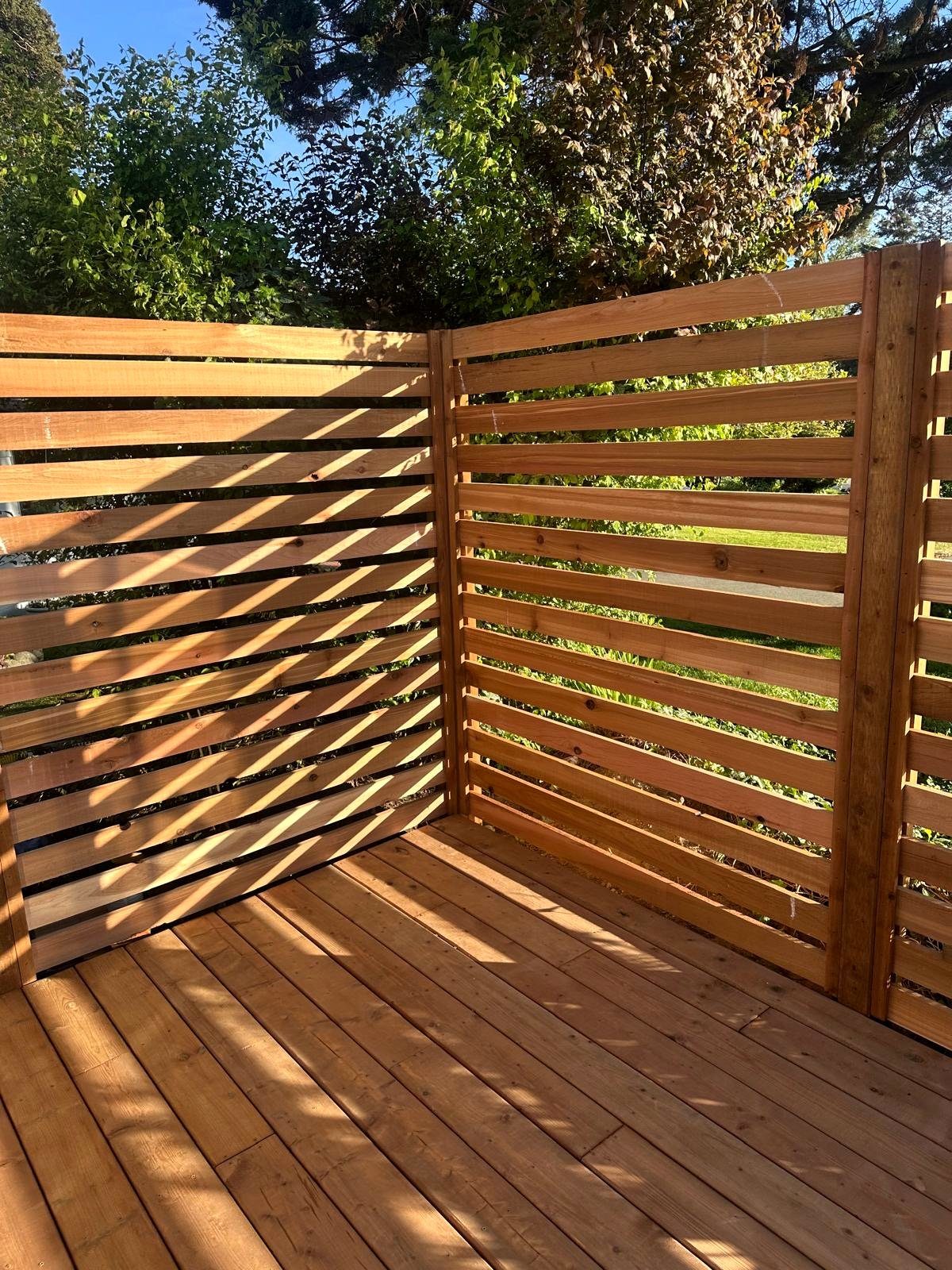 Hand-built cedar slat fence screen in a Vancouver backyard